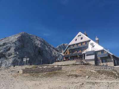 A photo of a hut under the Triglav mountain